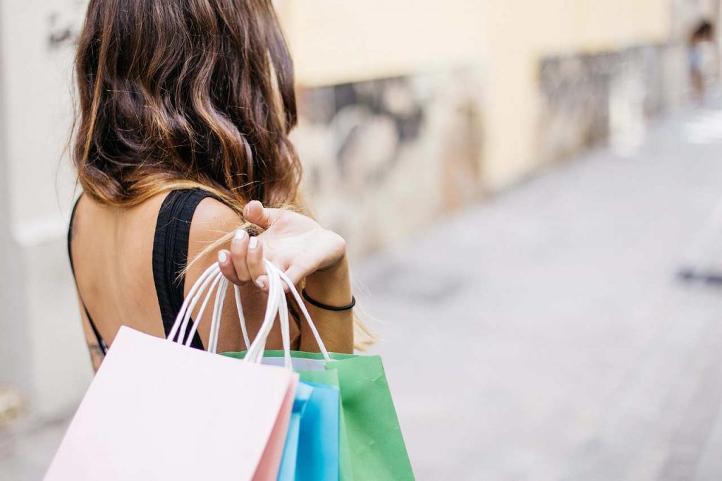 Woman Holding Shopping Bags From Behind